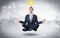 Businessman meditates with enlightenment concept