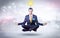 Businessman meditates with enlightenment concept