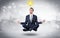 Businessman meditates with enlightenment concept