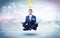 Businessman meditates with enlightenment concept