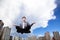 Businessman meditating in the air