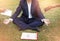 Businessman is meditating to relieve stress. young business man