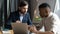 Businessman mentor training African American intern, giving instructions