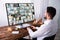 Businessman Monitoring CCTV Camera Footage On Computer