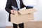 Businessman moving out with cardboard box