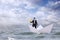 Businessman navigates the open sea atop a paper boat, absorbed in a book