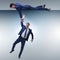 The businessman offering helping hand to falling colleague