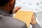 Businessman open brown envelope for evaluating business report, examining report papers on table in office.