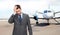 Businessman over airplane on runway background