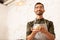 Businessman owning cafe holding cup of coffee with milk