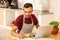 Businessman owning cafeteria working on laptop and making notes