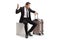 Businessman in panic sitting with a suitcase and looking at his watch