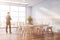 Businessman in panoramic white cafe interior