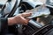 businessman pays for a product or service  gives dollars while sitting in the car