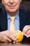 Businessman peeling an orange