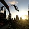 A businessman performing a slam dunk on the top of a skyscraper.