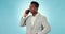 Businessman, phone and serious communication in studio for networking, discussion or conversation on blue background