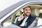 Businessman is phoning while driving a car