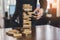 Businessman picking wooden block fail danger tower