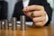 Businessman picks coins on the table, counts money . Business concept