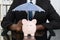 Businessman With Piggybank And Umbrella