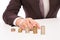 Businessman Placing Coin Over Stack At Desk