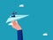 Businessman pointing a direction to a paper airplane. Help support the achievement of goals. business concept