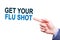 Businessman pointing on Get Your Flu Shot text sign. Isloated on