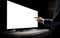 Businessman pointing index finger at tv or computer monitor. Blank screen for adding text, logo, photo or video. Generative Ai