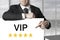 Businessman pointing on sign vip golden stars