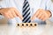 Businessman pointing to the wooden blocks with the word \'kasko\' written on it