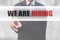 Businessman pointing word We are hiring