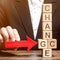 Businessman points to wooden blocks with the word Change to Chance. Personal development. Career growth or change yourself concept