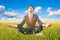 Businessman practice meditation in flower field