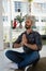 Businessman in prayer position meditating while sitting on floor