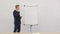 Businessman presenting something on flipchart on the meeting at the office