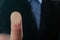 Businessman pressing control glass of biometric fingerprint scanner, closeup.