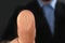 Businessman pressing control glass of biometric fingerprint scanner, closeup.