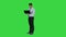 Businessman pressing play button to start or initiate projects or presentation on laptop on a green screen, chroma key.