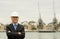 Businessman / property developer type wearing dark suit and white construction safety helmet.