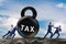 Businessman pulling kettlebell in tax concept