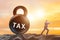 Businessman pulling kettlebell in tax concept