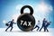 Businessman pulling kettlebell in tax concept