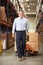 Businessman Pulling Pallet In Warehouse