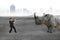 Businessman pulling rope against rhinoceros on concrete floor