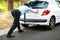 Businessman, push vehicle or breakdown on road engine fail, emergency tyre or auto service. Male person, strength and