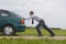 Businessman pushing a car