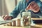 businessman puting coins into jug glass. concept saving money an