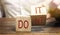 Businessman puts wooden blocks with the words Do it and don`t. The concept of motivation and self-development. Goal achievement