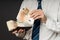 Businessman putting banknotes in his wallet. Stack of fifty euros money. Business man is holding cash. Person pays in euro bills